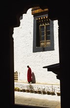 Bhutan, Tango, Buddhist Monastery, Monk standing in the courtyard. 
Photo Nic I'Anson