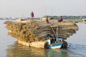 Bangladesh, Industry, Transport, Boat heavily laden with a cargo of jute stems on river.