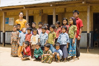 Bangladesh, Chittagong Division, Bandarban, Students and teachers stood outside a small primary