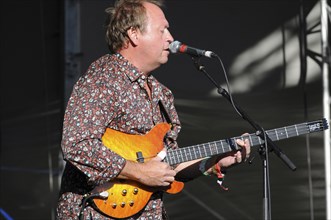 Music, Strings, Guitars, Mark King bass player with Level 42 playing at Guilfest 2010. . 
Photo