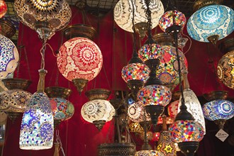 Turkey, Istanbul, Fatih, Sultanahmet, Kapalicarsi, Display of ornate coloured glass lamps in the