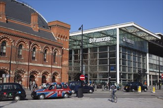 England, London, Taxi cabs outside the entrance to St Pancras Railway Station. 
Photo Stephen