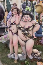 Spain, Valencia Province, Valencia, Two female Papier Mache figures in the street during Las Fallas festival.