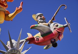 Spain, Valencia Province, Valencia, Papier Mache figure flying an airplane resembling a fish during