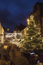 England, Hampshire, Winchester, High street decorated with Christmas tree and decorations, seen from the Buttercross.