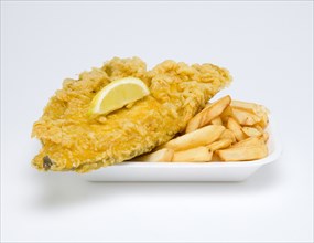 Food, Cooked, Fish, A portion of battered deep fried plaice with a slice of lemon and potato chips.