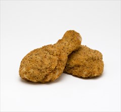 Food, Cooked, Poultry, Two breaded chicken drumsticks on a white background.