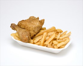 Food, Cooked, Poultry, Battered chicken breast fillet and drumstick with potato chips in a polystyrene foam tray on a white background.