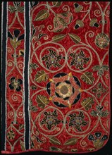 Chasuble; embroidered re-used red satin with black satin & silver thread appliqué tudor roses & flowers; English; 1550 - 59.