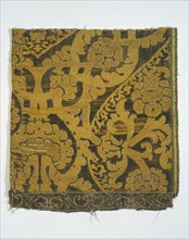 Textile - woven silk & gold thread; with floral & scroll motifs in old gold on brown; Italian; 16th century.