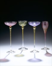 Four tall stemmed drinking glasses; enamelled & gilded; possibly by Theresienthaler Krystallglasfabric; possibly German; c.1900.