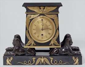 Mantle Clock; black marble, with mounts of Ormolu and patinated bronze, gilt dial;made by Benjamin Lewis Vulliamy (1780 - 1854),design from Denon's Voyage dans la Haute Egypte (pub. London 1802);Engli...