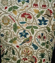 Lady`s jacket of linen embroidered with coloured silks, silver and silver-gilt thread in a pattern of scrolls, flowers, birds and butterflies - detail;  English; c.1620.