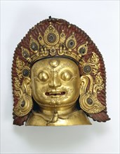 "Sculpture- Mask of Bhairava; copper, repousse gilt; Tibetan; pre 17th century."