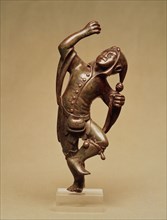 Jester figure forming a stand for candlestick. Germany, 15th century