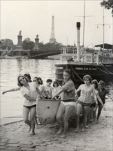 Young girls of the Sophie Germain High School in Paris getting their canoe out of the water