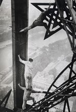 Acrobat electricians working on the Eiffel tower