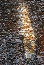 Detail of running water on a rock