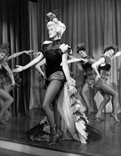 Film still of Jayne Mansfield on stage in The Sheriff of Fractured Jaw