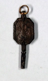 Clock key with Masonic motifs.