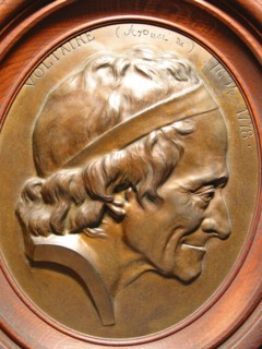 Wooden medallion in an oval frame depicting Voltaire