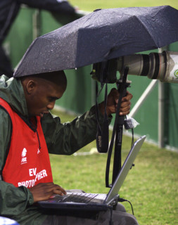 A photographer busy at work sending his pictures through to meet the deadlines.Hundreds of