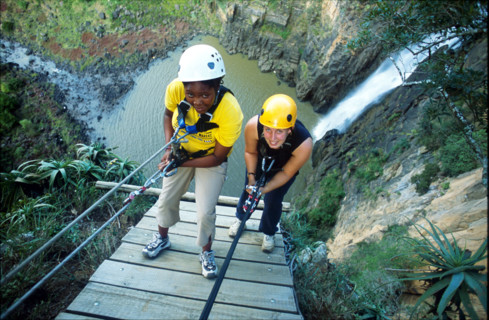 abseiling next to a waterfall
