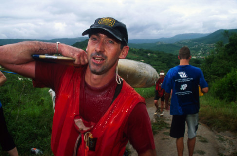 guy carrying front of double, red shirt looking into camera