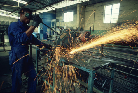 Man using a metal drop saw
\n