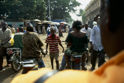 Photographer Rassim Keita gave me a lift on the back of his motorbike to the post office in the