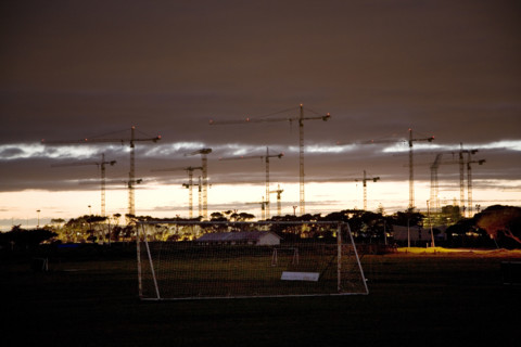 Seen from soccer fields in Greenpoint, construction cranes rise above the site of the new