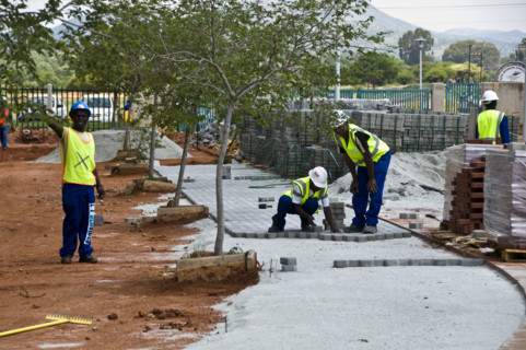 Workers lay paving at The Royal Bafokeng Sports Palace in Phokeng near Rustenburg.  The stadium