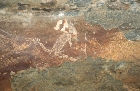 A weird white figure with splayed legs, arrow in hand and hair s