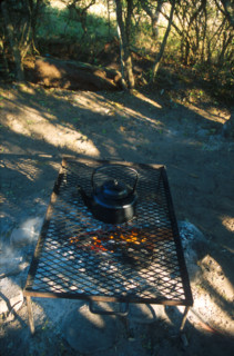 heating water in a kettle over a fire