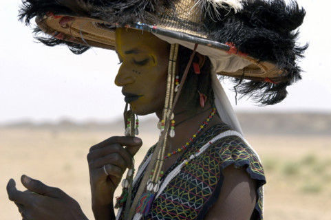 Wodaabe men examine their appearance in handmirrors at a festival in InGall, near Agadez in Niger