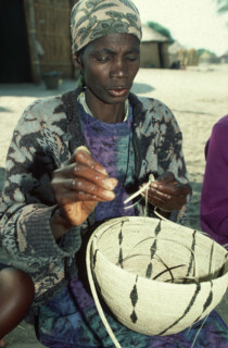 Lady weaving a basket