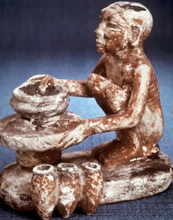 Potter turning vessels on a wheel:  Limestone model