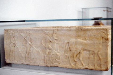 Ancient Greek warrior stepping into his chariot
