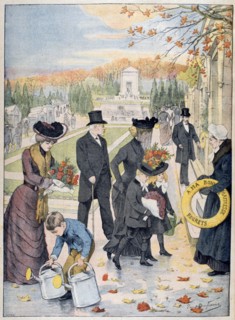 All Saints Day: Familiy visiting cemetery with flowers