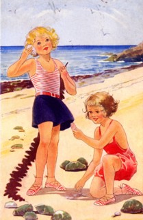 Girls playing with shells on a sandy beach on their seaside holiday