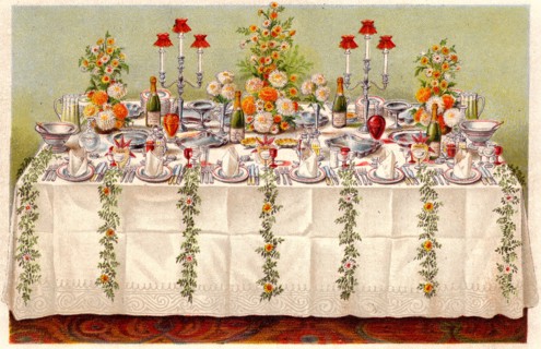Table covered with a linen cloth and set for a buffet for ball or an evening party