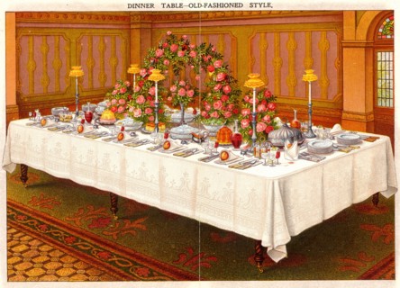 Table covered with a linen cloth and set for a formal dinner party