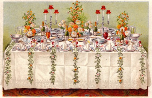Table covered with a linen cloth and set for a buffet for ball or an evening party