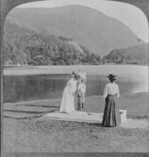 Woman and boy with golf clubs in foreground