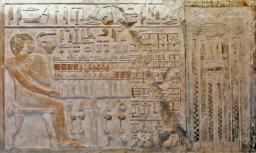 Bas relief Egyptian depicting a seated male figure