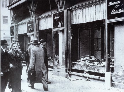 Pedestrians glance at the broken windows