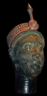 Brass head with a beaded crown and plume