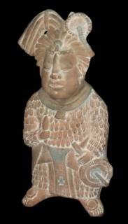 Mayan priest holding a knife and a fan