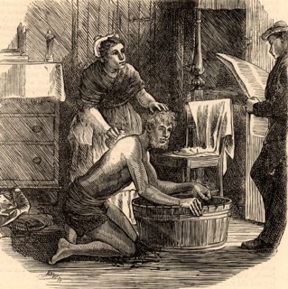 A coal miner cleaning up after  work with the help of his wife