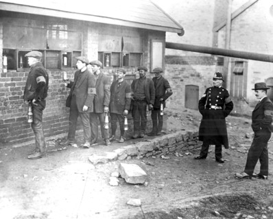 Strike-breaking coal miners in the Rhondda Valley, Wales, with their lamps before going down the
